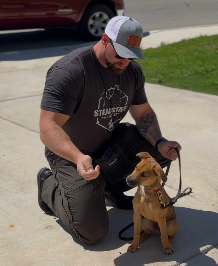 Kyle of Steady State K9 training a young dog on leash in San Antonio, Texas